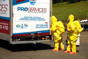 Pro Services Crew in Hazmat Suits at the back of their truck